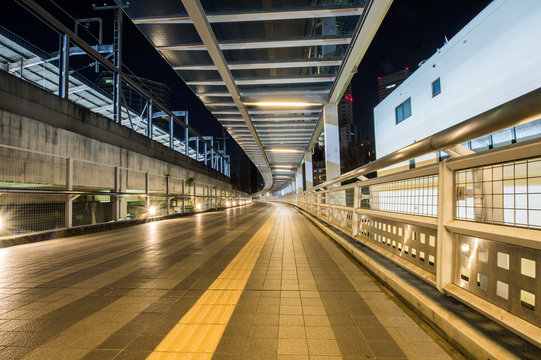 Covered pedestrian bridge at night, in Saitama, Japan.