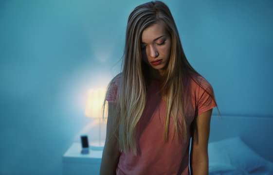 Young sleepy woman suffering from somnambulism at home