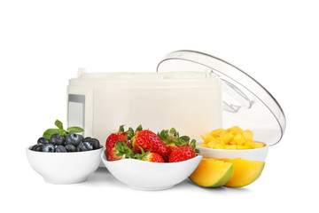 Modern yogurt maker and ingredients on white background