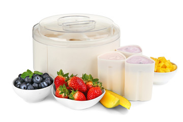 Modern yogurt maker and ingredients on white background