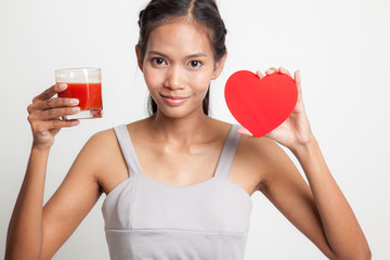 Young Asian woman with tomato juice and red heart.