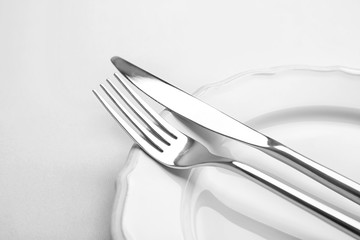 Fork and knife on plate, close up