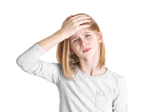 Cute girl suffering from headache on white background