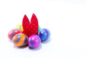 Six hand colored easter eggs with Easter Bunny ears in the middle of them