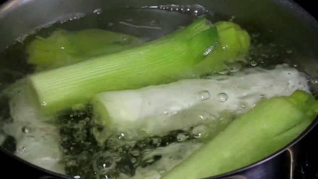 cooking leeks in a metal pot 