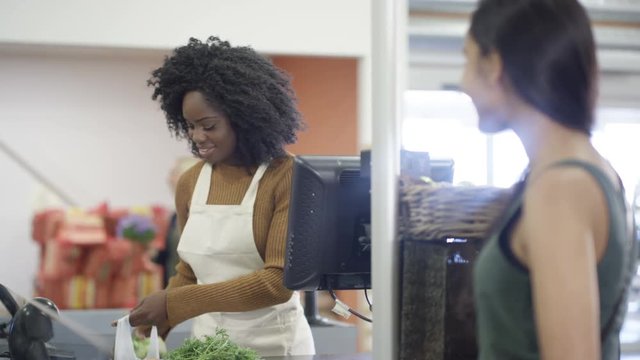  Cashier Taking Credit Card Payment From A Customer At Grocery Store Checkout