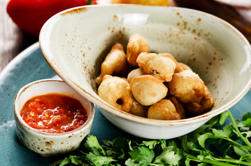 Chuchvara. Fried dumplings with lamb and spicy sauce. Traditional dish of cuisine in Central Asia