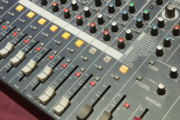 The mixer table or fader board for music production in light blue scene with the lighting effect
