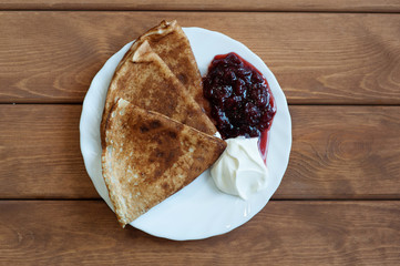 Pancakes with jam and sour cream