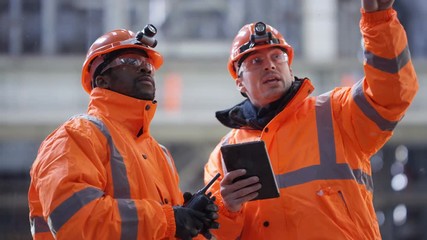 Team of engineers conducting checks at power station - Powered by Adobe