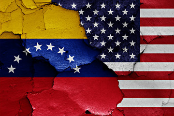 flags of Venezuela and USA painted on cracked wall