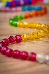 snake of colored beads on a wooden background