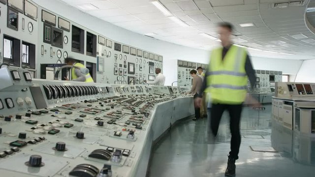  Time lapse of busy team of engineers working together inside power station