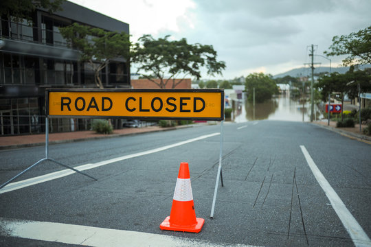 Flooded road in Brisbane and Road Closed sign