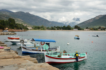 Fototapeta na wymiar Small fishing boats in the bay of Sagone