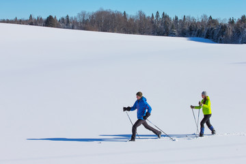 Couple cross country skiing in winter