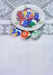 Easter plate with hand-painted eggs on a beautiful tablecloth