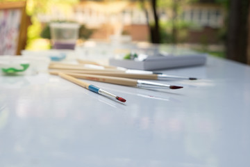 Fototapeta premium Used paint brush on white table.