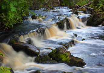 Fototapeta na wymiar Waterfall on forest stream long exposure