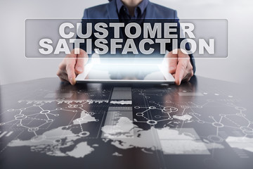 Businessman using tablet pc and selecting customer satisfaction.