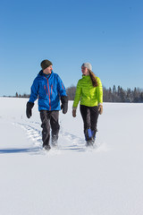 Couple Snowshoeing in fresh snow