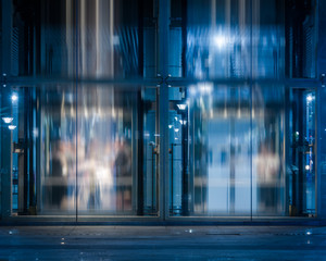 Glass Entrance Of modern office building at night in Shanghai,China.