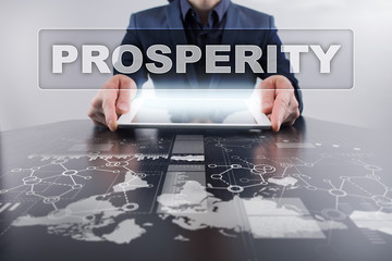 Businessman using tablet pc and selecting prosperity.