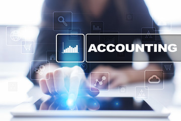 Woman using tablet pc, pressing on virtual screen and selecting accounting.