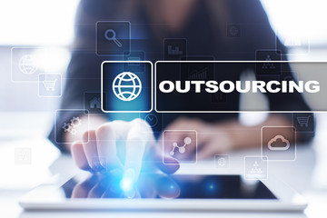 Woman using tablet pc, pressing on virtual screen and selecting outsourcing.