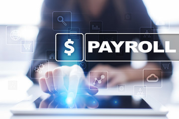 Woman using tablet pc, pressing on virtual screen and selecting payroll.