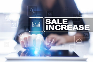 Woman using tablet pc, pressing on virtual screen and selecting sale increase.