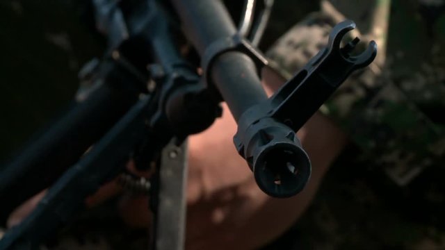 Close-up military pkm weapon on camouflage background