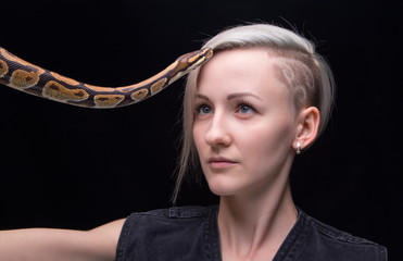 Portrait of blond woman with python