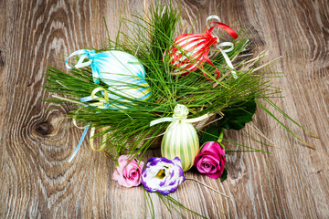 Easter eggs with flowers on wooden background. Toned image