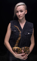 Blond woman holding royal python