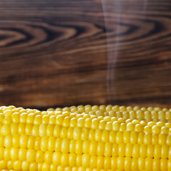 Fresh hot corn on cobs on rustic wooden table, closeup. Selective focus