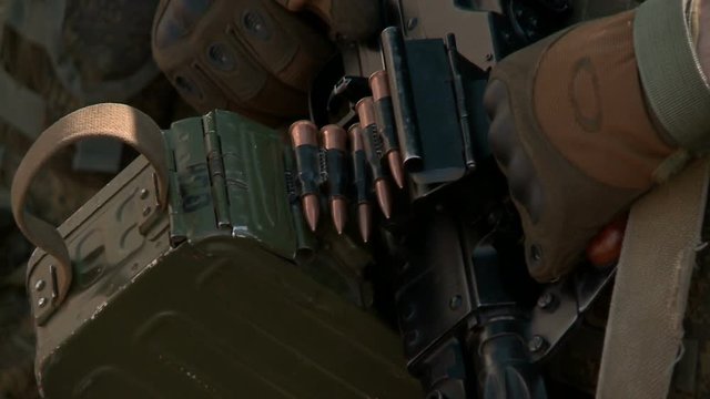 Close-up military pkm weapon on camouflage background