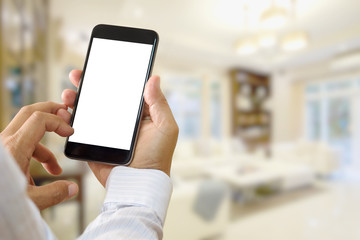 Man using smartphone at living room blur background.