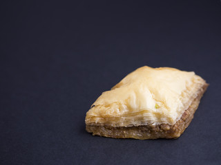 Baklava with nuts isolated on black background