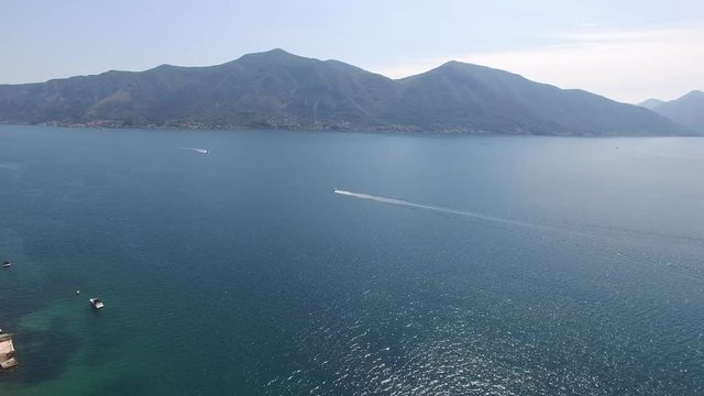 Boat in the Bay of Kotor. Montenegro, the water of the Adriatic Sea. Aerial Photo drone.
