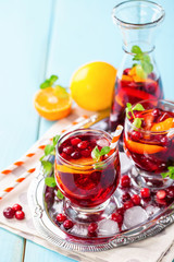 Summer drink Sangria with orange and cranberry. Selective focus. Copy space