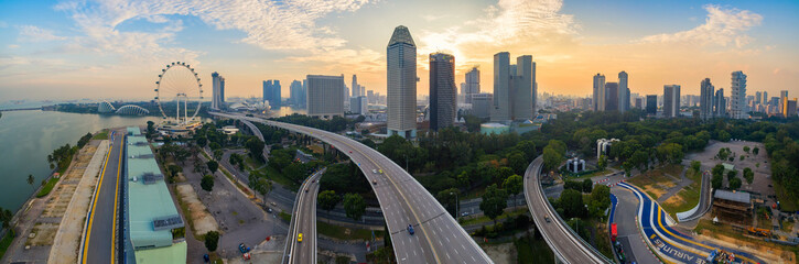 Aerial view of Singapore city skyline on high way in sunrise or sunset at Marina Bay, Singapore - obrazy, fototapety, plakaty