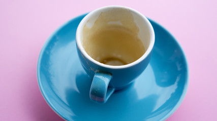 empty blue cup with rest of coffee