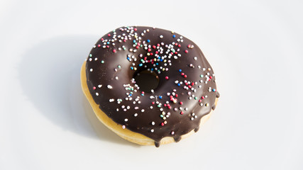 chocolate donut with colorful toppings.