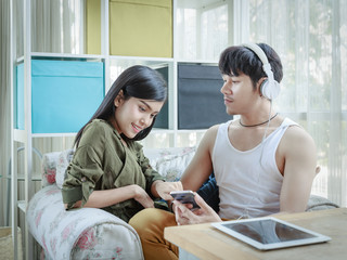 Asian Couple Listening To Music