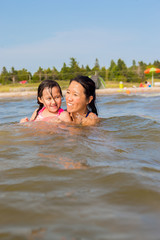 Fototapeta na wymiar Mixed race father and daughter at the beach