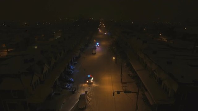 Cops inspecting cars on snow emergency route