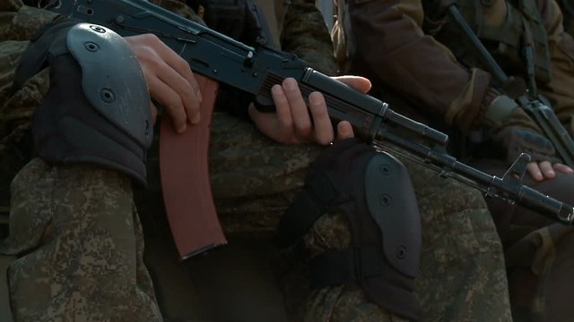 Close-up military ak-47 weapon on camouflage background