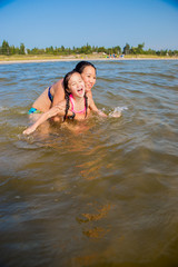 Mother and Daughter play at the beach