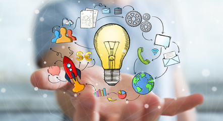 Businessman holding hand drawn lightbulb and multimedia icons